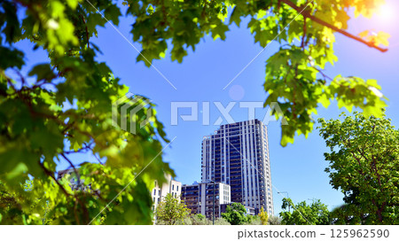 Eco apartment building saving energy and fresh air. Modern block of flats in green area, residential apartment and luxury house complex.  125962590