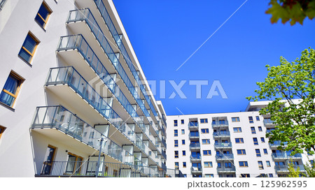 Eco apartment building saving energy and fresh air. Modern block of flats in green area, residential apartment and luxury house complex. Eco apartment building saving energy and fresh air. Modern block of flats in green area, residential apartment and luxury house complex. 125962595