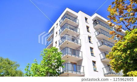Eco apartment building saving energy and fresh air. Modern block of flats in green area, residential apartment and luxury house complex. Eco apartment building saving energy and fresh air. Modern block of flats in green area, residential apartment and luxury house complex. 125962605