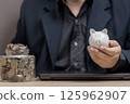 man hold piggy bank for Smart Savings and Investments for Financial Growth. strategies for saving money and 125962907