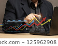 businessman uses technology to analyze business and financial data. graphs showing market trends, economic growth and investment decisions and filled with elements help make data analysis accurate. 125962908