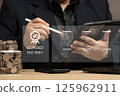 Quality Assurance in Financial Investments and Business Services. man reviewing quality control checklists on a tablet, ensuring service excellence and customer satisfaction. QC PASSED ISO 9001. 125962911