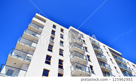Modern new residential apartment house building complex. Exterior view of modern apartment building. New construction apartment or condo complex. 125962981