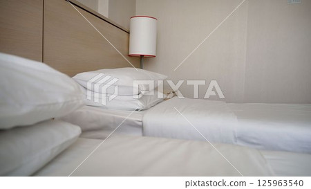 Hotel room beds getting ready Hotel room beds getting ready 125963540