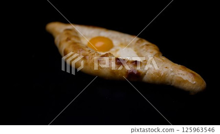 Adjarian khachapuri rotating on black background 125963546
