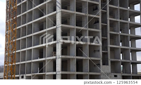 Construction site showing concrete building frame and crane Construction site showing concrete building frame and crane 125963554