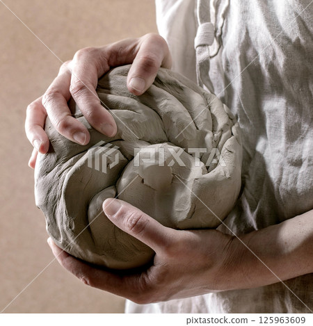 Pottery clay in femail hands Pottery clay in femail hands 125963609