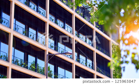 Modern city eco office building with tree. Detail shot of modern architecture facade,business concepts. Environment. Modern building and trees, double exposure. 125963847