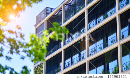 Modern city eco office building with tree. Detail shot of modern architecture facade,business concepts. Environment. Modern building and trees, double exposure. 125963851