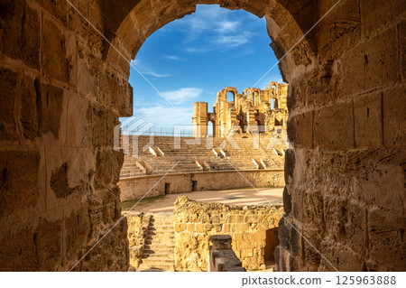 View from the arch to ancient african Roman Colosseum amphitheatre arena, ruins and columns, El Jem, Mahdia View from the arch to ancient african Roman Colosseum amphitheatre arena, ruins and columns, El Jem, Mahdia 125963888