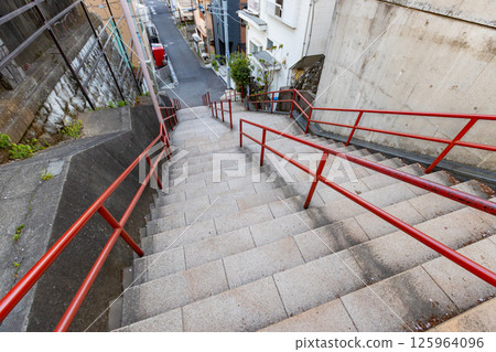 Suga Shrine in Shinjuku, Tokyo: The staircase with the red handrail that became famous in the movie scene Suga Shrine in Shinjuku, Tokyo: The staircase with the red handrail that became famous in the movie scene 125964096