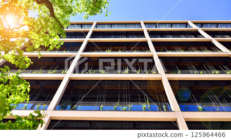 Modern city eco office building with tree. Detail shot of modern architecture facade,business concepts. Environment. Modern building and trees, double exposure. 125964466