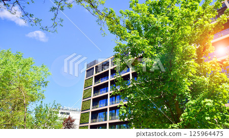 Modern city eco office building with tree. Detail shot of modern architecture facade,business concepts. Environment. Modern building and trees, double exposure. 125964475