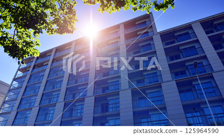 Eco apartment building saving energy and fresh air. Modern block of flats in green area, residential apartment and luxury house complex.  125964590