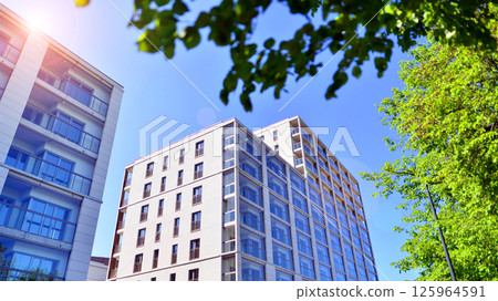 Eco apartment building saving energy and fresh air. Modern block of flats in green area, residential apartment and luxury house complex. Eco apartment building saving energy and fresh air. Modern block of flats in green area, residential apartment and luxury house complex. 125964591