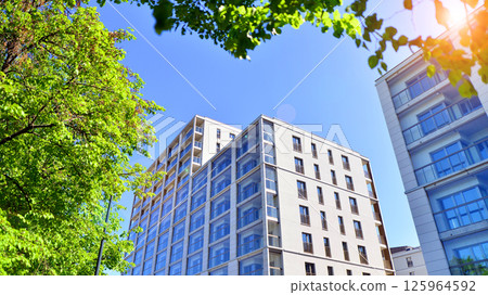 Eco apartment building saving energy and fresh air. Modern block of flats in green area, residential apartment and luxury house complex. Eco apartment building saving energy and fresh air. Modern block of flats in green area, residential apartment and luxury house complex. 125964592