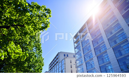 Eco apartment building saving energy and fresh air. Modern block of flats in green area, residential apartment and luxury house complex. Eco apartment building saving energy and fresh air. Modern block of flats in green area, residential apartment and luxury house complex. 125964593