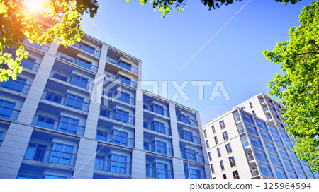 Eco apartment building saving energy and fresh air. Modern block of flats in green area, residential apartment and luxury house complex.  125964594