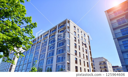 Eco apartment building saving energy and fresh air. Modern block of flats in green area, residential apartment and luxury house complex.  125964606