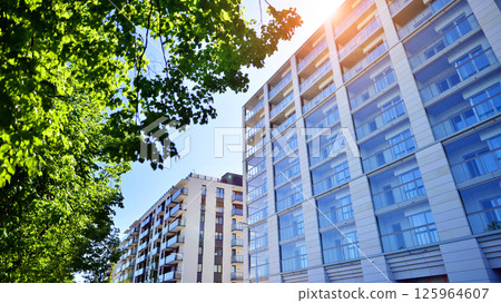 Eco apartment building saving energy and fresh air. Modern block of flats in green area, residential apartment and luxury house complex.  125964607