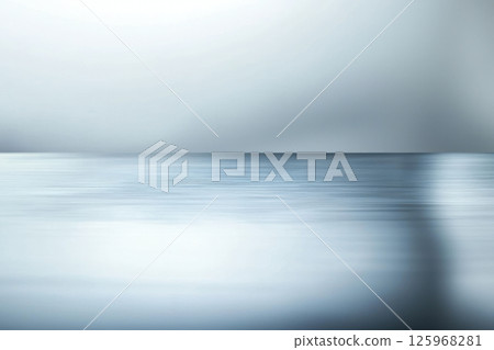 serene metallic surface with subtle reflections in cool grey tones, creating blank foreground that evokes tranquility 125968281