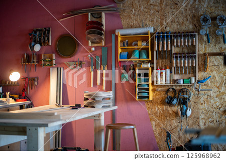 Professional carpenter workshop with tool cabinet and workbench for custom furniture creation 125968962