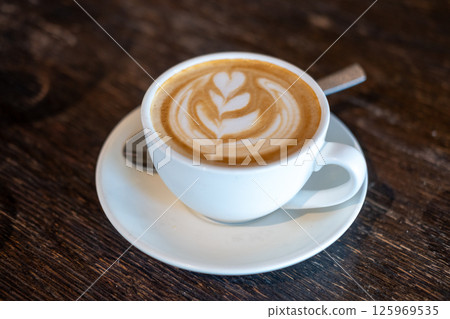 A cup of coffee with latte art, on the table 125969535