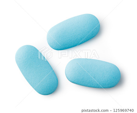 Three light blue medical pills isolated on white background 125969740