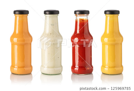 Four glass bottles containing different sauces on white background 125969785