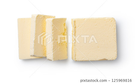 Butter block and slices resting on white background 125969816