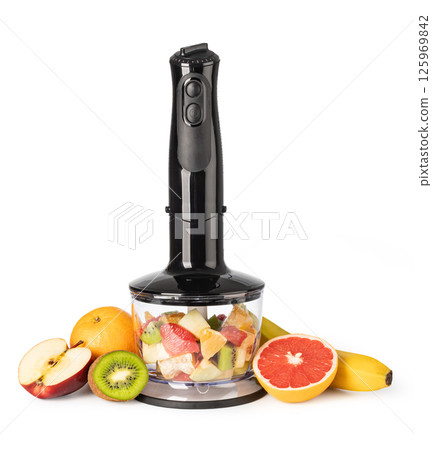 Immersion blender preparing a fruit salad on white background 125969842