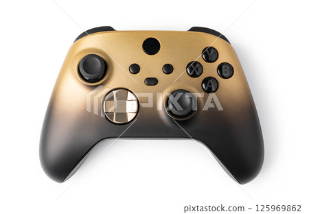 Black and gold video game controller resting on white background 125969862