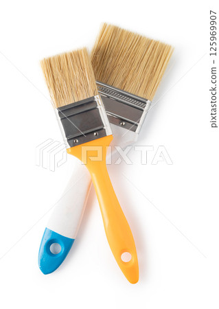 A white paintbrush with a blue handle. The brush is clean and ready to use. A white paintbrush with a blue handle. The brush is clean and ready to use. 125969907