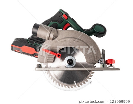 A circular saw power tool with a green handle and a silver blade 125969909