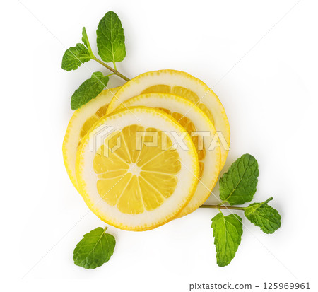 Sliced lemon with mint on white background representing freshness and flavor Sliced lemon with mint on white background representing freshness and flavor 125969961