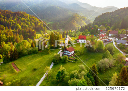 Calm idyllic village in Slovenian mountains at sunrise, summer travel concept 125970172
