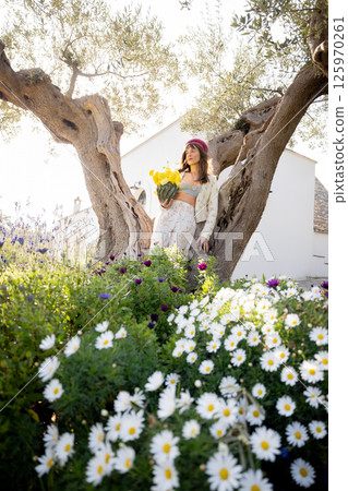 Spring blooms and olive tree 125970261