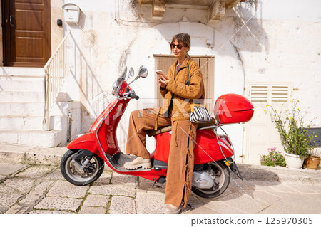 Italian ride with a red Vespa 125970305