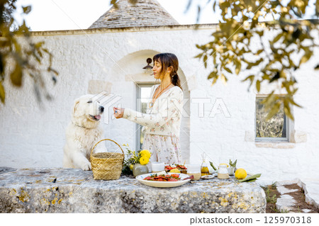 Lunch Break with Dog in Puglia Garden 125970318