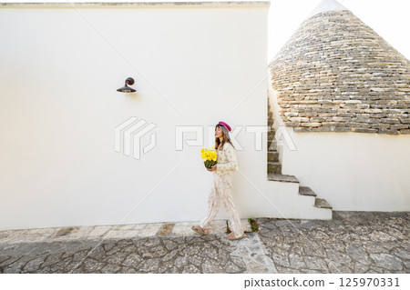 Yellow flowers and stone roof 125970331