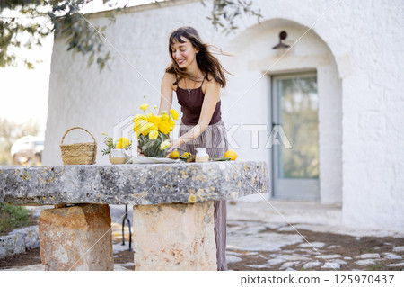 Arranging lemons and ranunculus outside Arranging lemons and ranunculus outside 125970437