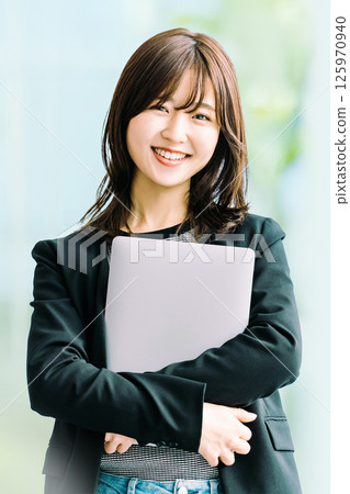 Smiling woman/businesswoman with a laptop Smiling woman/businesswoman with a laptop 125970940