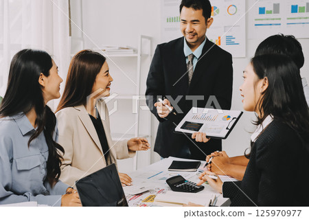 Team of financial advisory services. Asian advisor showing plan of investment to clients in the consultancy office. Team of financial advisory services. Asian advisor showing plan of investment to clients in the consultancy office. 125970977