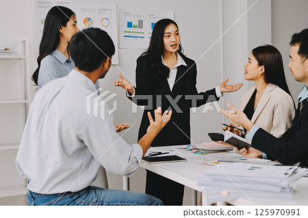 Team of financial advisory services. Asian advisor showing plan of investment to clients in the consultancy office. Team of financial advisory services. Asian advisor showing plan of investment to clients in the consultancy office. 125970991