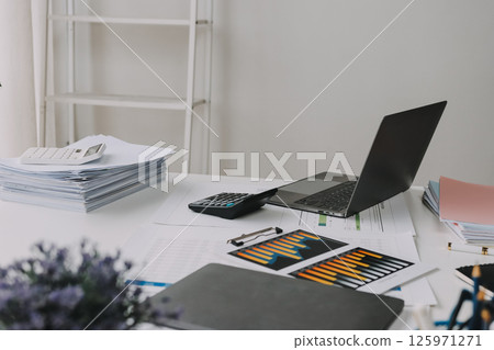 Team of financial advisory services. Asian advisor showing plan of investment to clients in the consultancy office. Team of financial advisory services. Asian advisor showing plan of investment to clients in the consultancy office. 125971271