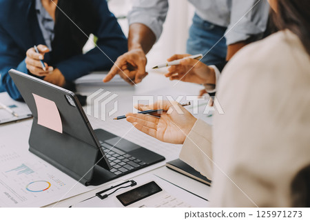 Team of financial advisory services. Asian advisor showing plan of investment to clients in the consultancy office. 125971273