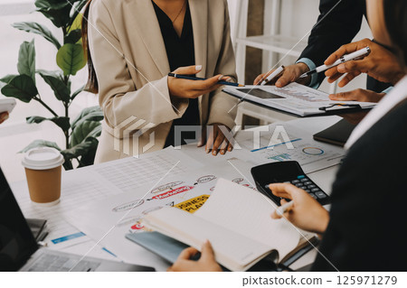 Team of financial advisory services. Asian advisor showing plan of investment to clients in the consultancy office. 125971279