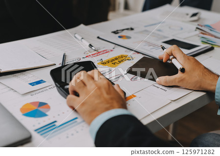 Team of financial advisory services. Asian advisor showing plan of investment to clients in the consultancy office. 125971282