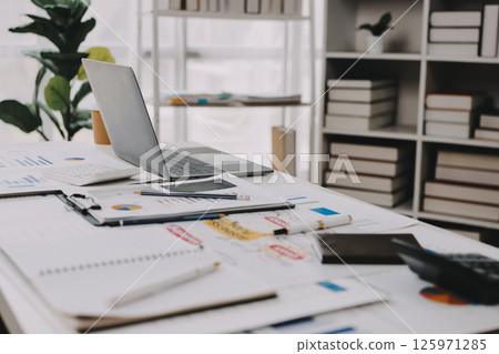 Team of financial advisory services. Asian advisor showing plan of investment to clients in the consultancy office. 125971285