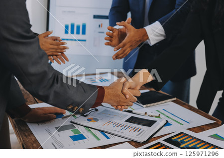 Business handshake for teamwork of business merger and acquisition,successful negotiate,hand shake,two businessman shake hand with partner to celebration partnership and business deal concept 125971296